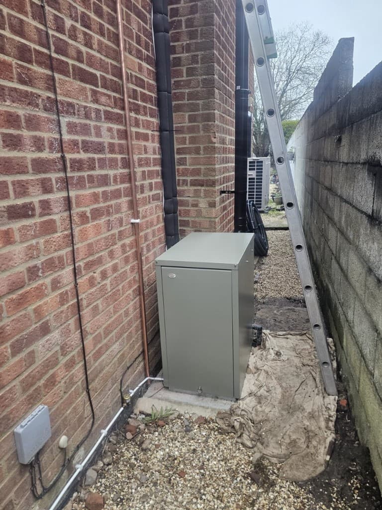 Grant Vortex external oil boiler installed in a side passage with copper pipework by APS