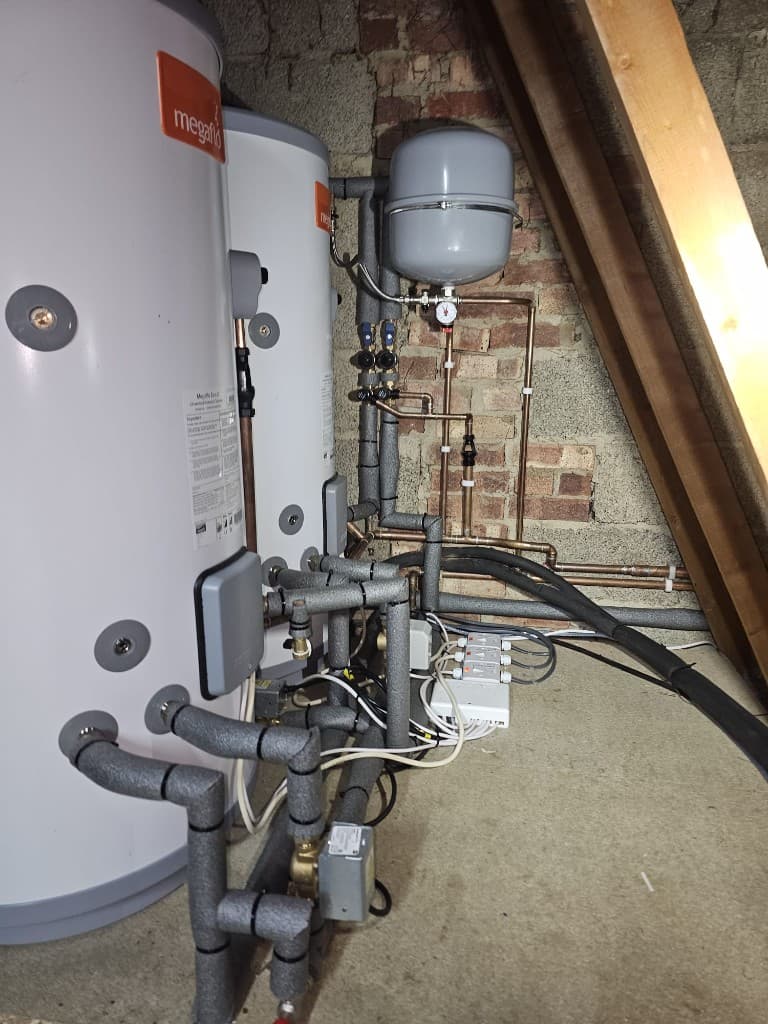 Twin Megaflo unvented hot water cylinders with insulated pipework installed by APS